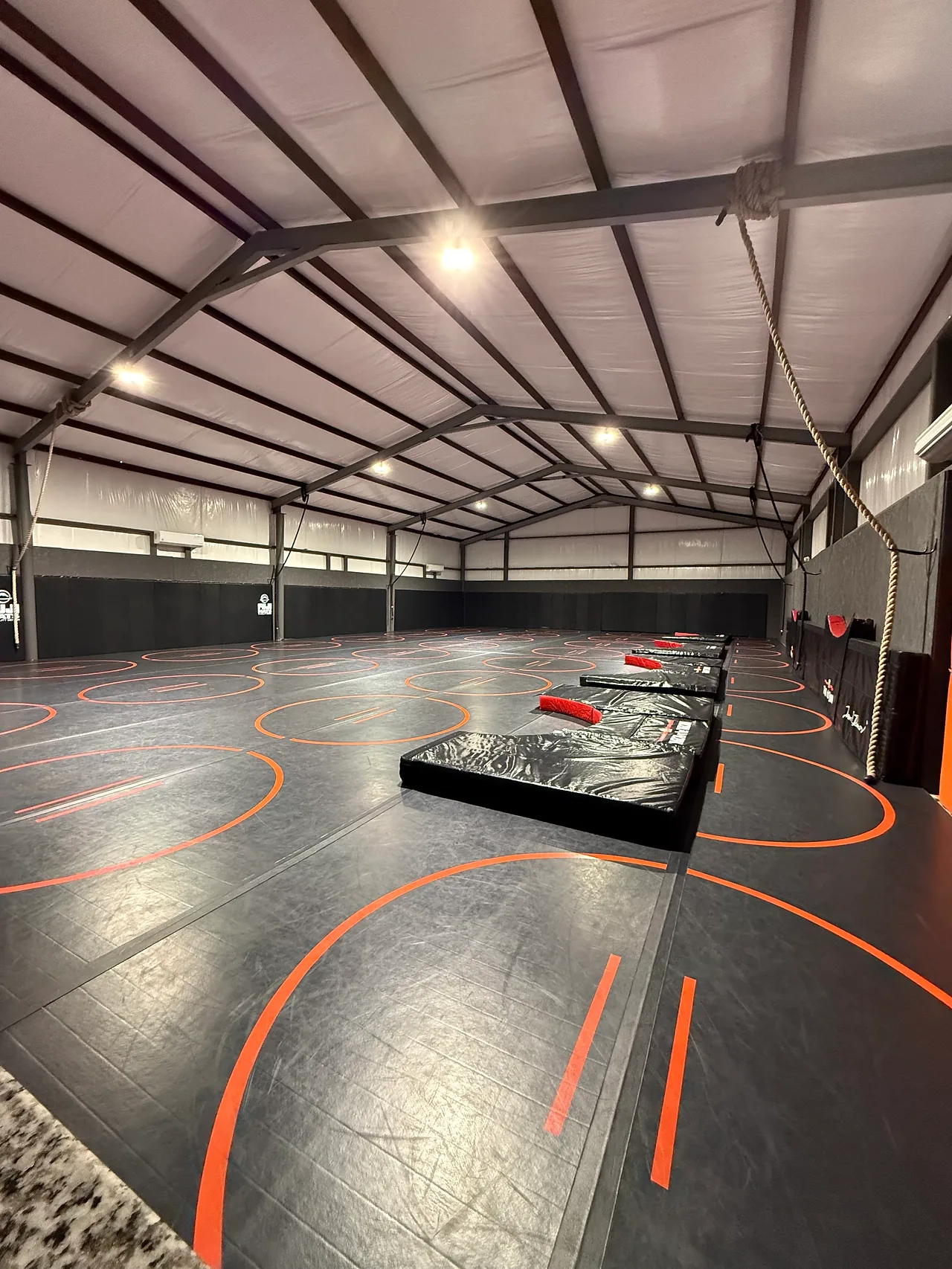 Fuji wrestling mats and padded walls inside Dead Shot Wrestling Club