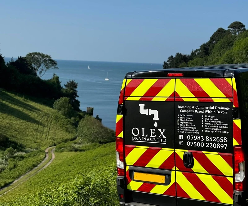 OLEX Drainage Ltd works van parked on a Devon hillside overlooking the South West coast
