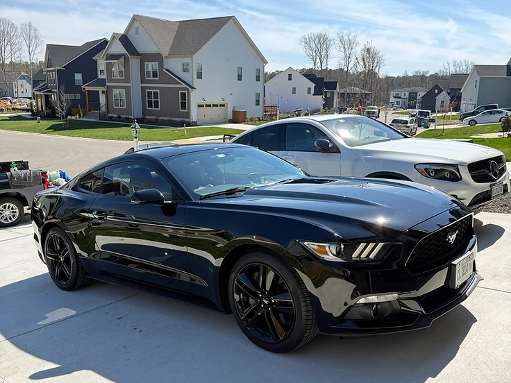 Glossy black Mustang with mirror-like paint reflection after a Yeshua Auto Spa paint enhancement in Richmond VA