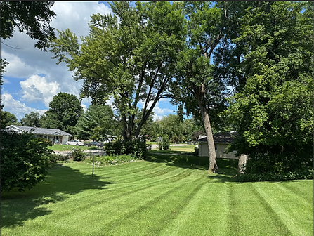 Backyard lawn cut with clean diagonal stripes by Get It Done Services in Evansville, Indiana