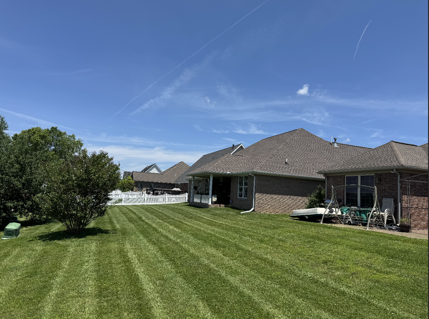 Residential lawn cut with clean mowing stripes