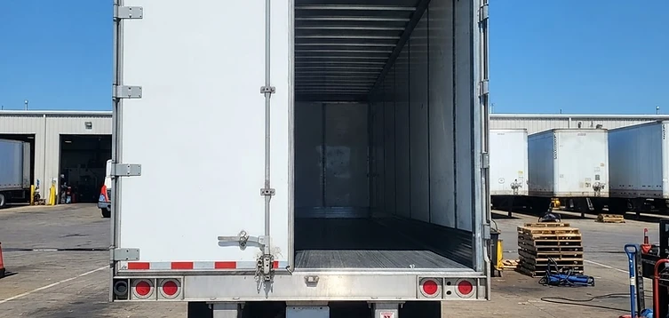 Rear of a commercial dry van trailer opened for inspection and repair