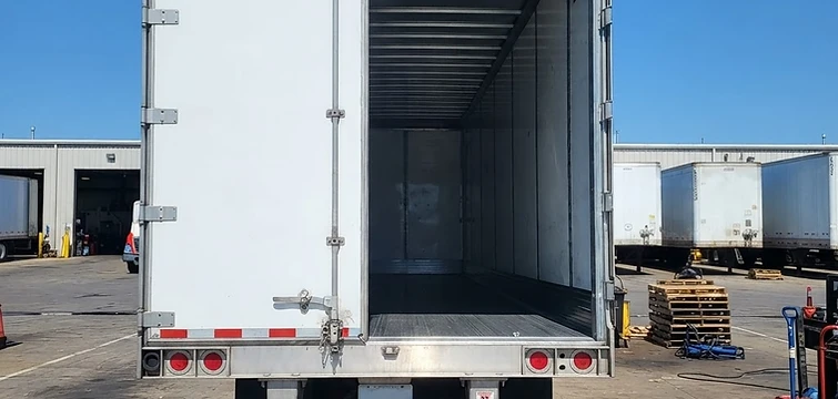 Rear of a commercial dry van trailer opened for inspection and repair