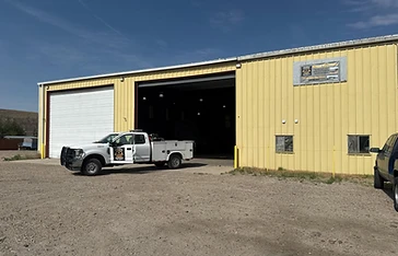 MTG Shops Green River, Wyoming repair shop with open bay door and a service truck parked outside