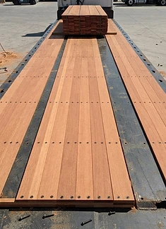 Fresh laminated hardwood trailer decking planks in the yard
