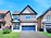Bright, inviting photo of a house with blue sky and green lawn