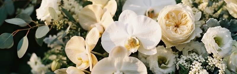 Elaborate white and cream floral arrangement with eucalyptus and ferns