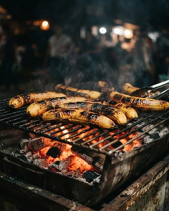 Charred grilled plantain halves over glowing embers