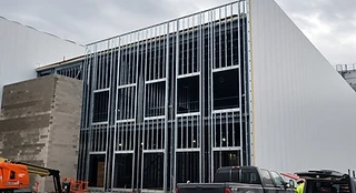 Exterior metal stud wall framing with window and door openings