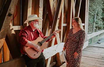 Faye and Corey laughing together inside a covered bridge