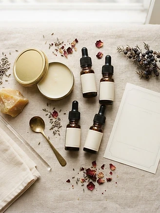 A complete DIY solid perfume set — tin, fragrance bottles, beeswax, tools, and an instruction card