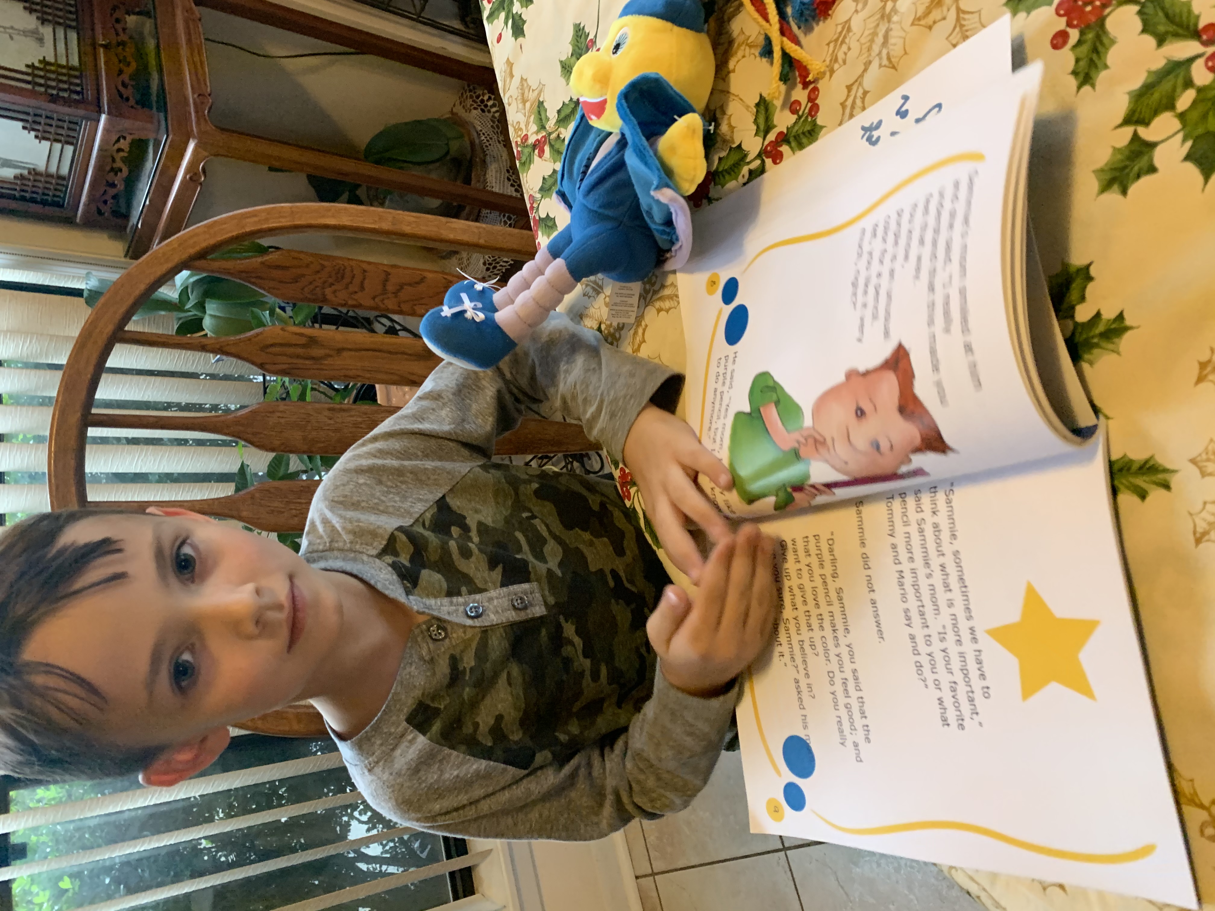 Aiden, working through a Toley Ranz story at the table.