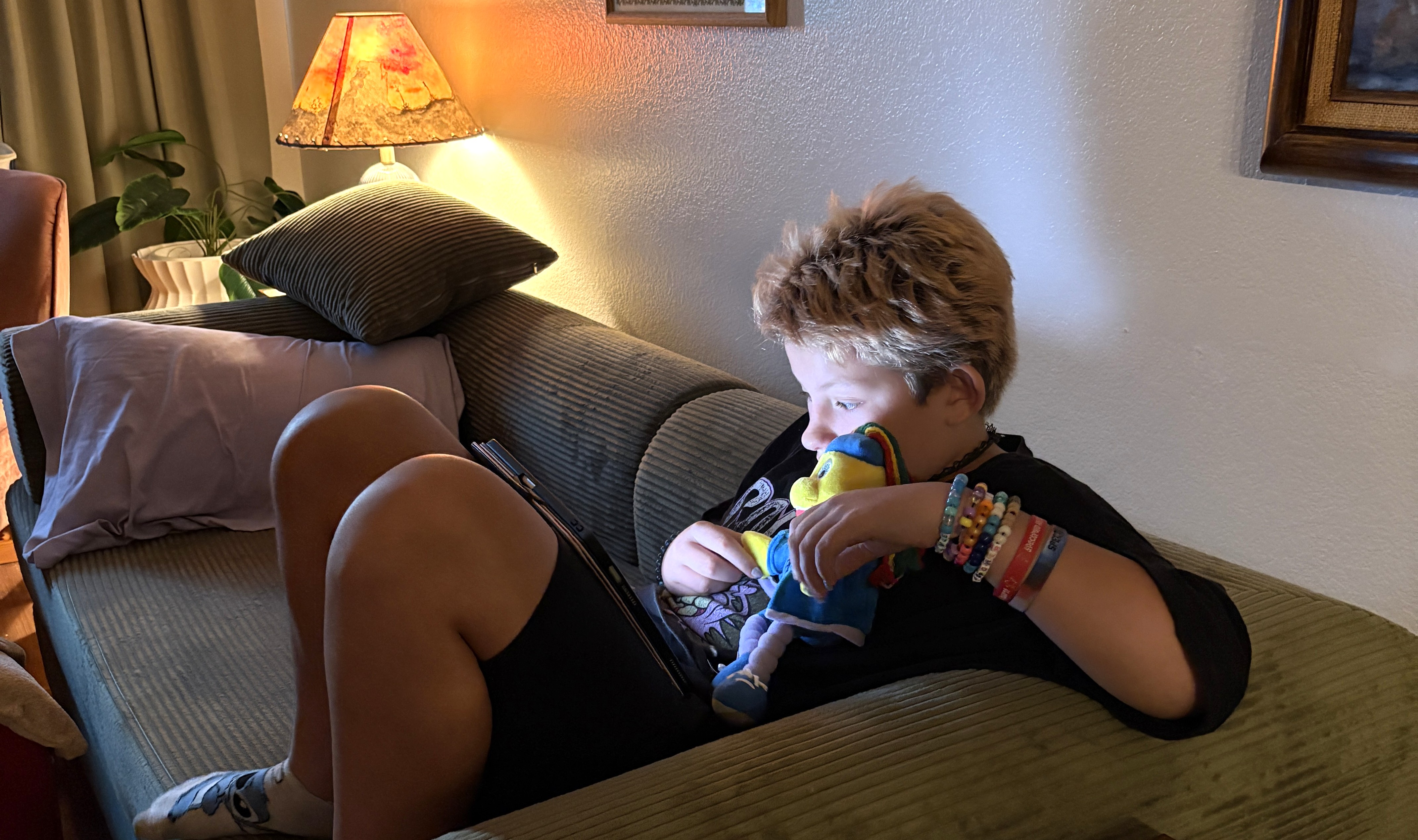 Dylan holding his Toley Ranz plush at home