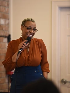 Dr. Sherman laughing while speaking with a microphone