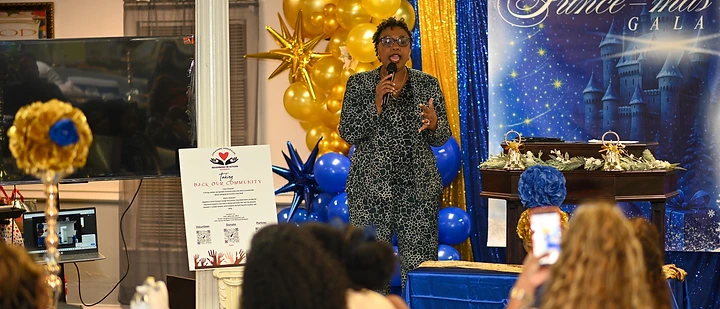 Dr. Maricia Sherman speaking at a community outreach gala