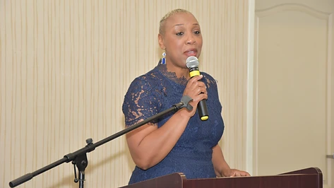 Dr. Sherman speaking at a podium during a conference event