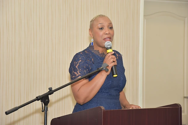 Dr. Maricia Sherman speaking confidently on stage at a leadership conference