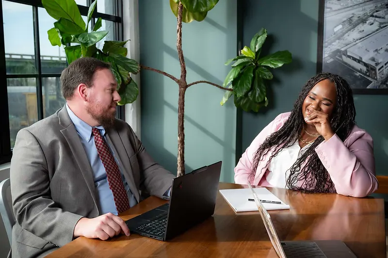 Sara Williams attorneys reviewing case files and legal documents together at the firm's office in Birmingham, Alabama