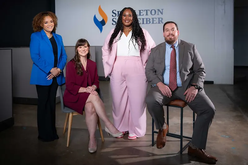 Sara Williams law firm team posed with Singleton Schreiber branding at the Birmingham, Alabama office