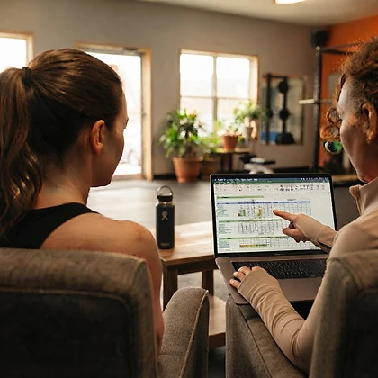 Two women reviewing a nutrition plan together on a laptop