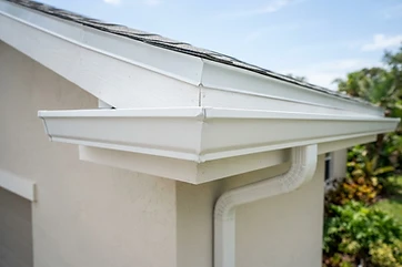 New white seamless aluminum gutter installed on a Florida roofline