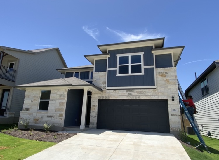 911 Gutter Team installing seamless gutters on a new-construction home in the Austin area