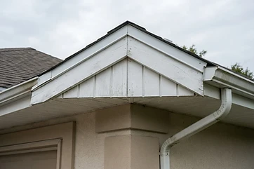 Roofline fascia board and soffit panels with water staining on an Austin-area home