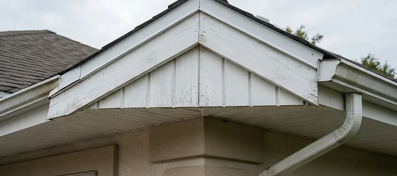Roofline fascia board and soffit panels with water staining on an Austin-area home