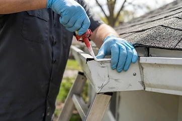 Resealing an aluminum gutter end cap seam on an Austin-area home