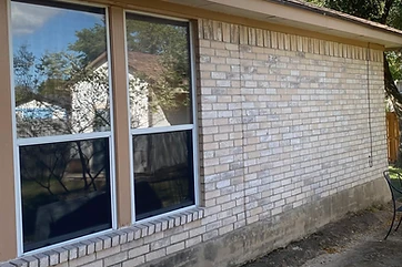 Bare roof edge with no gutters on a brick home in the Austin area