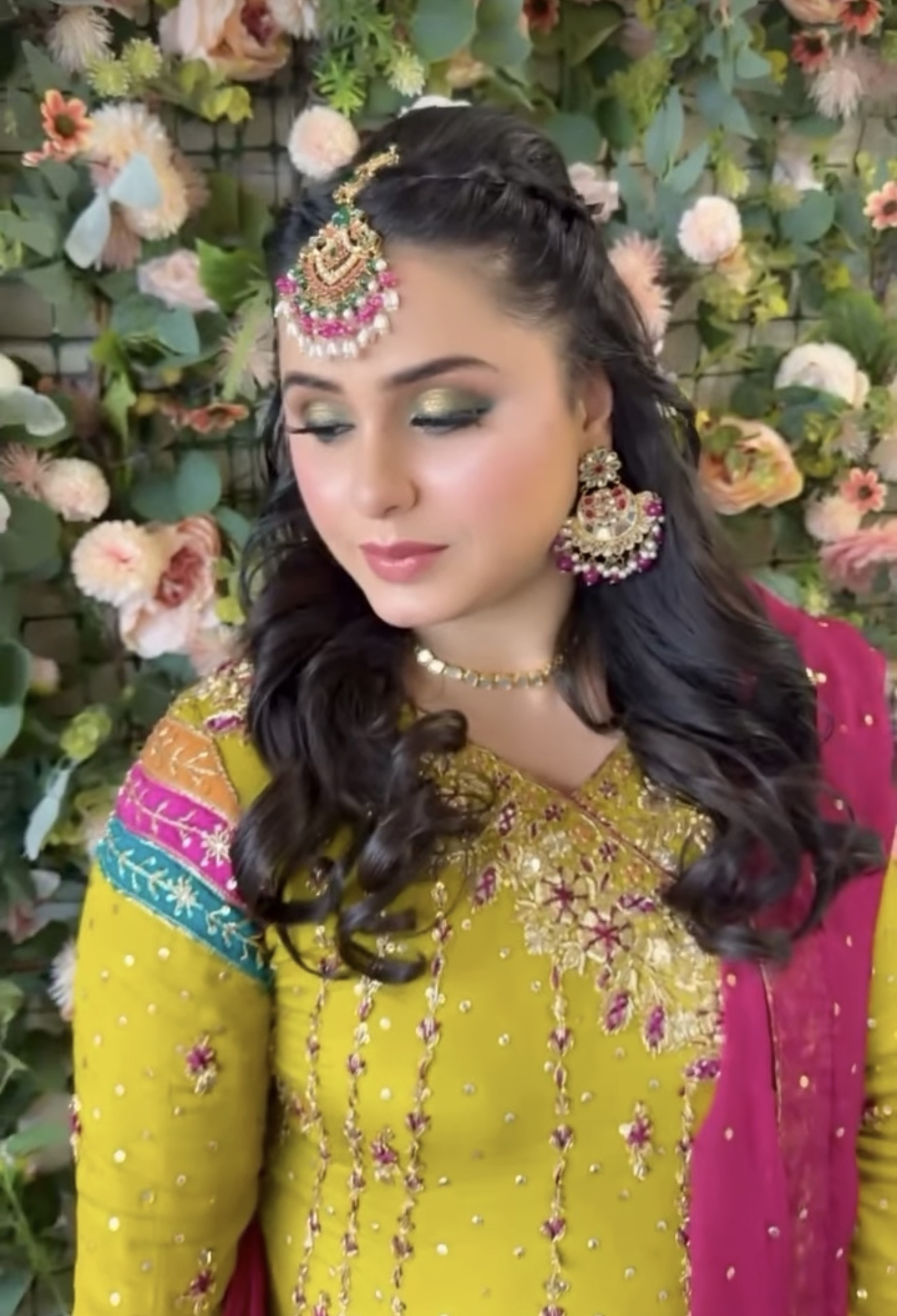 Bridal event styling with dark wavy hair gold maang tikka and traditional embroidered garment