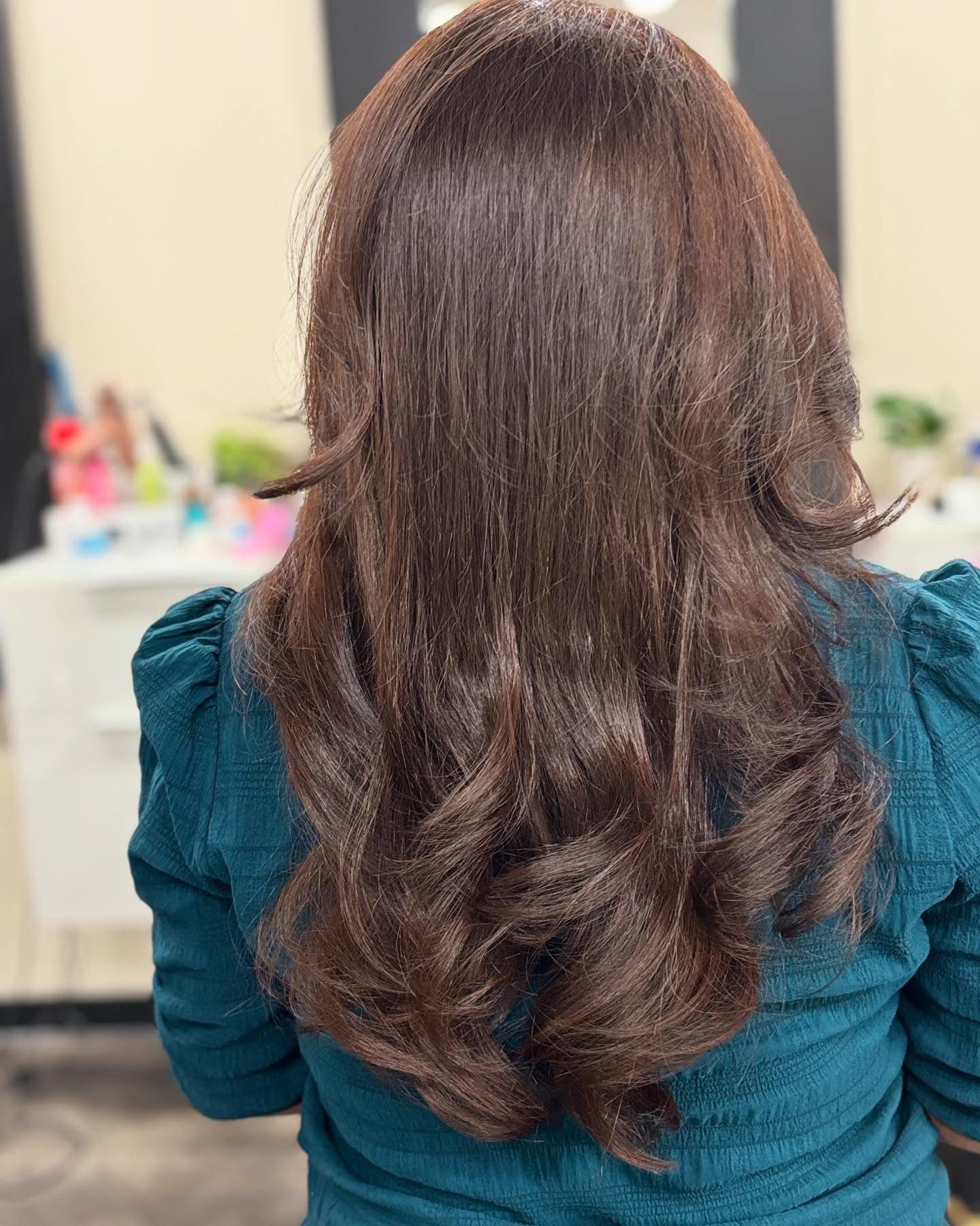 Long dark brown hair with a smooth crown and soft curled ends