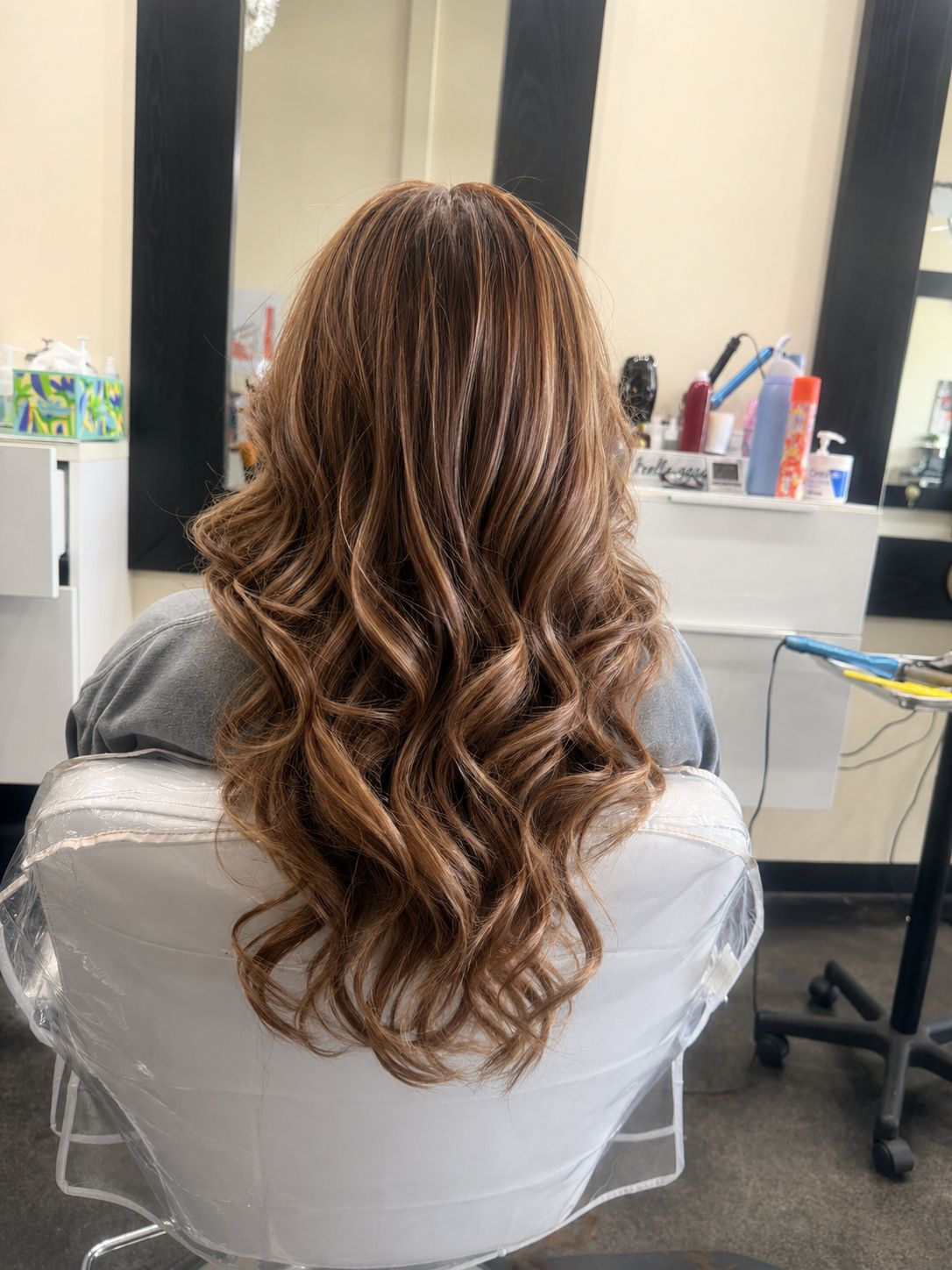 Long wavy brown hair with caramel highlights in loose voluminous waves