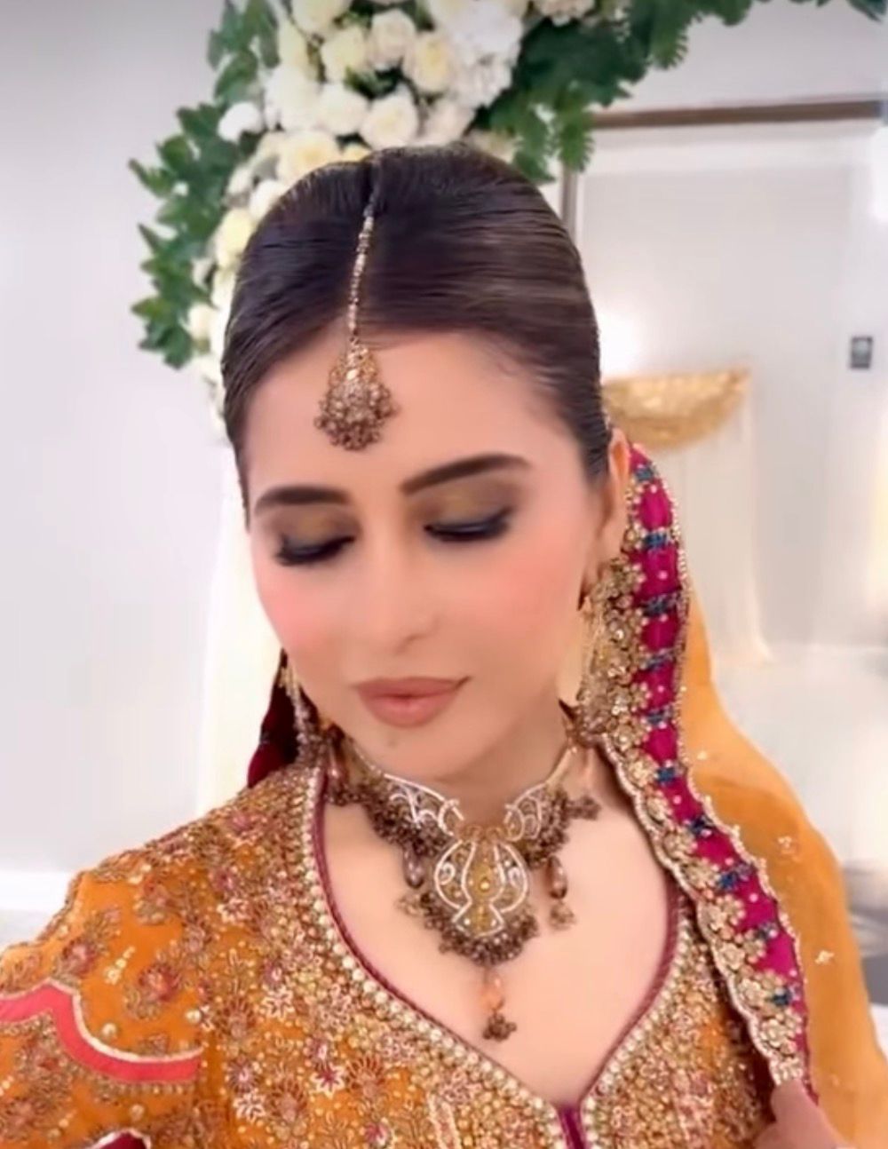 Bridal updo with ornamental headpiece and traditional embroidered garment