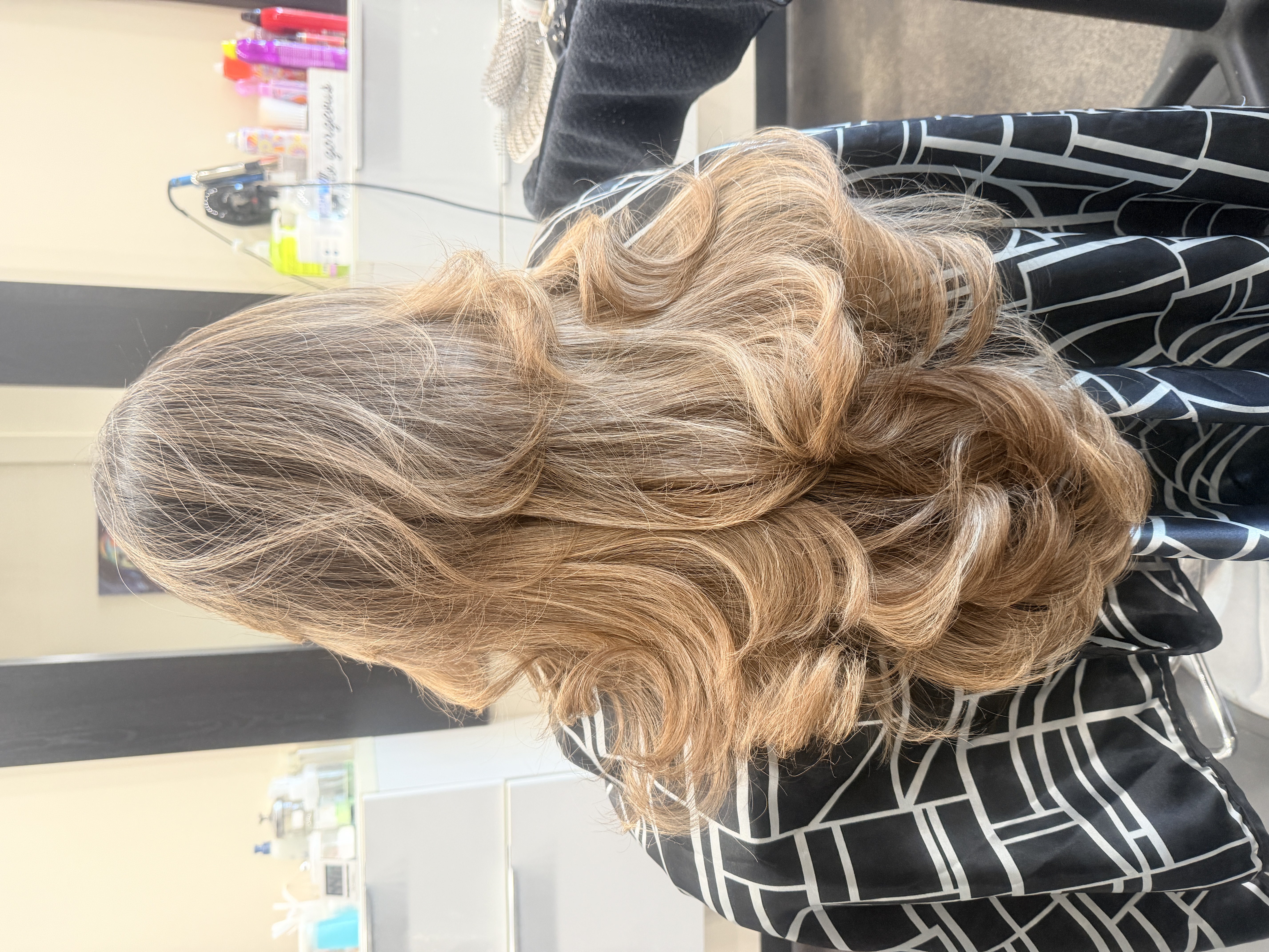 Light golden brown hair with highlights in loose voluminous waves