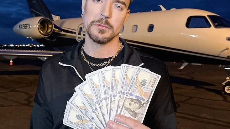 MrBeast holding a fan of hundred-dollar bills in front of a private jet at dusk, representing how he spends his millions on content and production