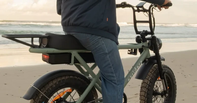 Riding a SLEDZ e-bike on Byron Bay beach at golden hour