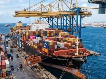Container ship being loaded at sea