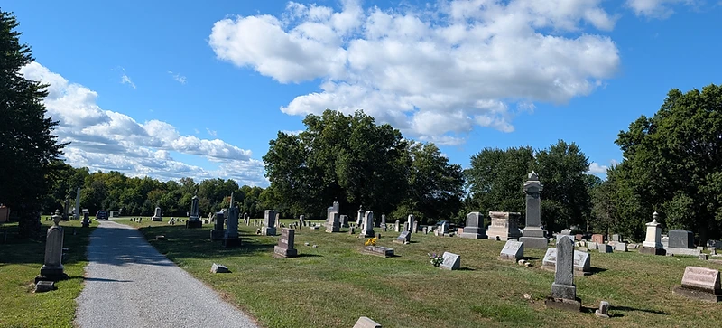 The Westfield Center Cemetery grounds, with a gravel path leading among the headstones and mature tree line