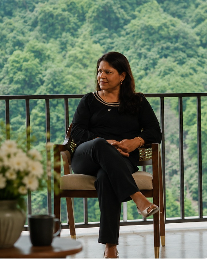 Priti, your host, seated on the balcony overlooking the forest