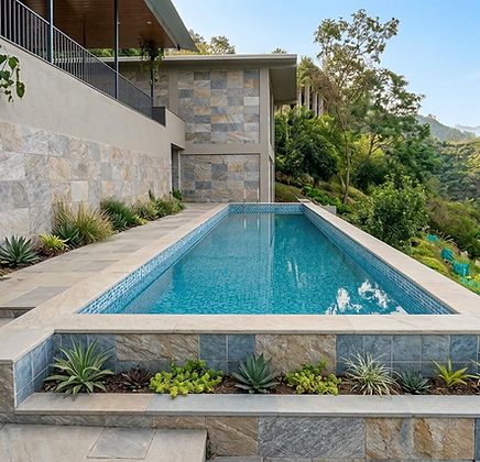 Daylight pool overlooking the green Himalayan hillside