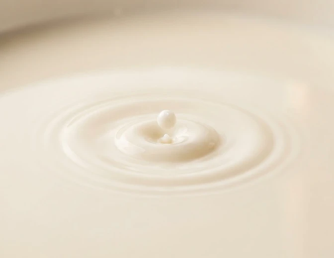 A single drop of human milk creating a delicate concentric ripple