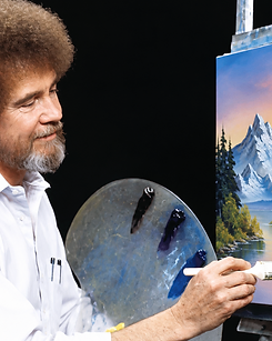 Bob Ross painting a mountain landscape at an easel