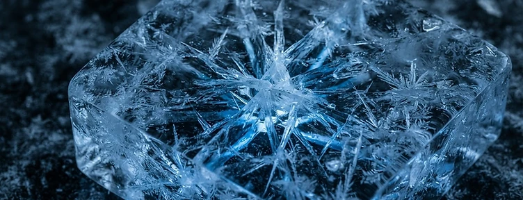Macro of cracked clear ice with blue refraction
