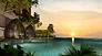 Sunset infinity pool with nest lounge pods at The Asteriaz