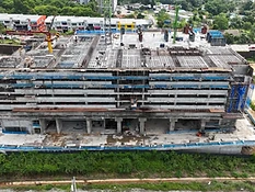 High-angle view of The Asteriaz construction site, Q3 2026 — crane and rebar slab works