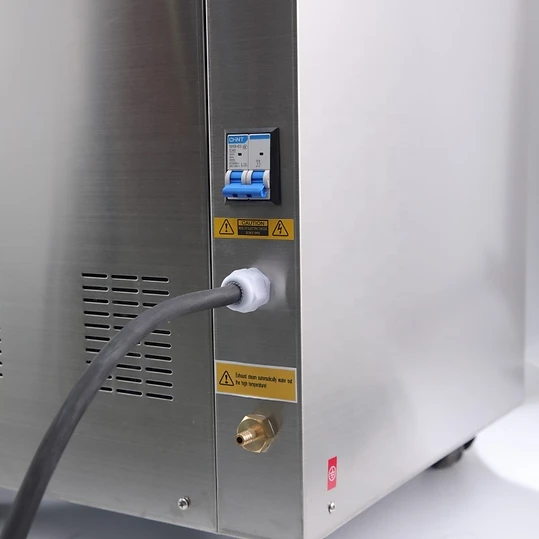 Side and back exterior of the 150L autoclave showing the circuit breaker, power input and drain fitting