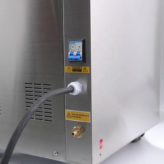 Side and back exterior of the 150L autoclave showing the circuit breaker, power input and drain fitting