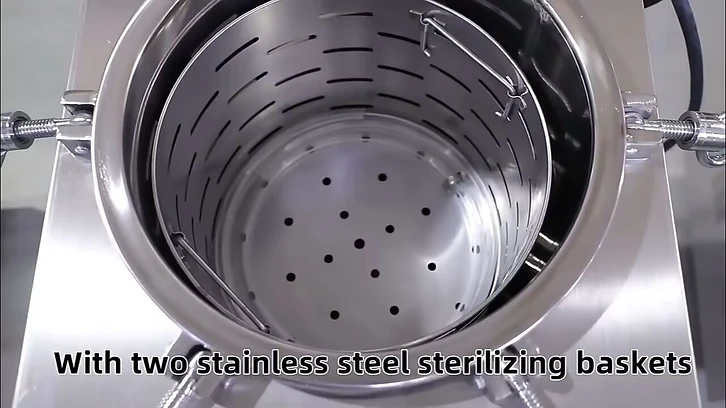 Top-down view into the open 150L autoclave chamber showing two stainless steel sterilizing baskets