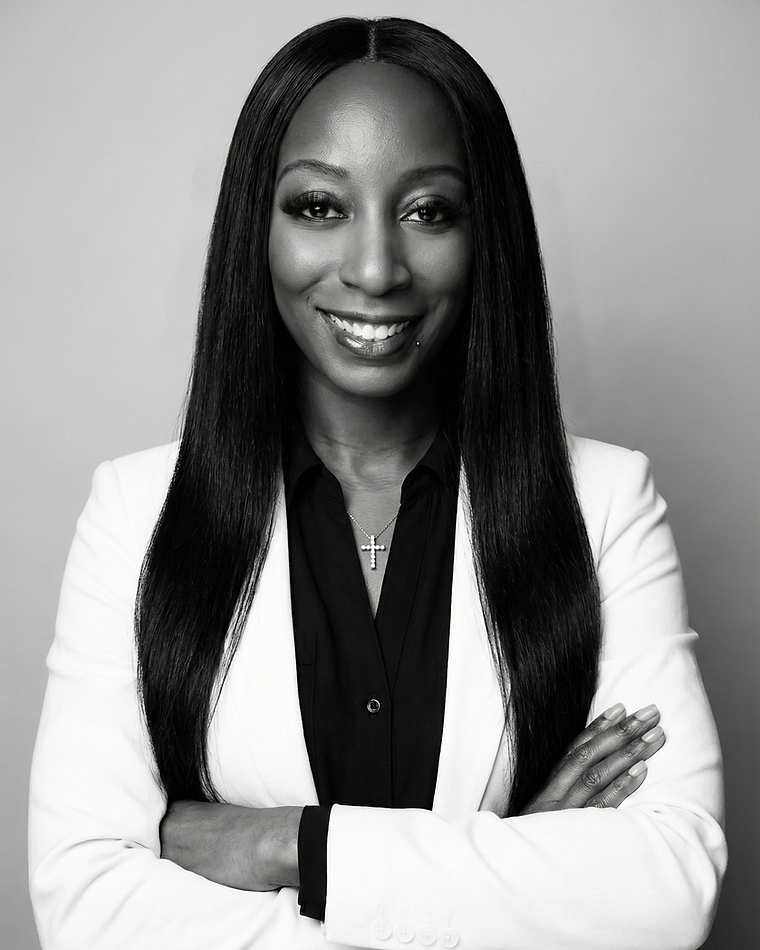 Portrait of Genesis Woods, Atlanta AI systems architect, arms crossed in a white blazer